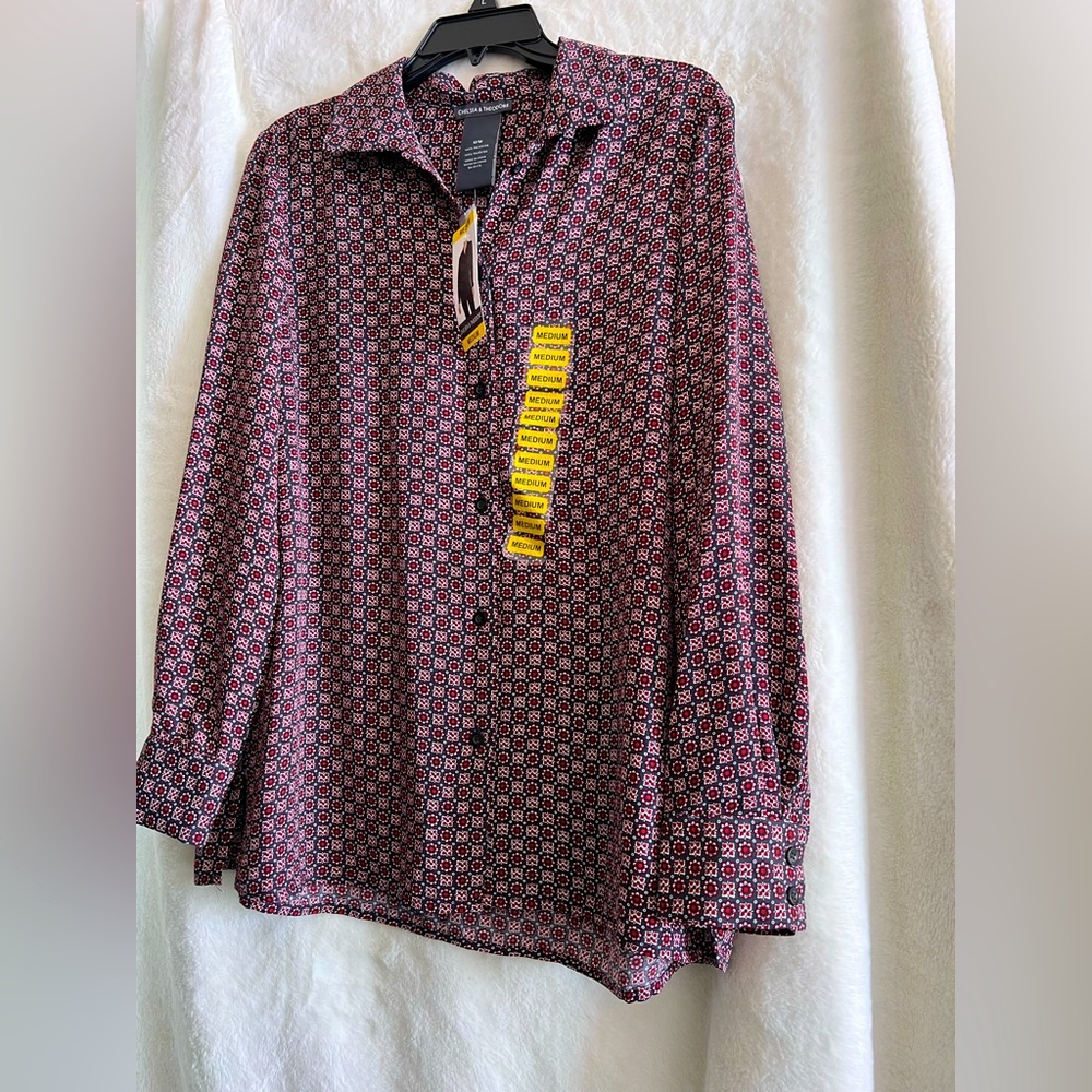 I’m selling a multicolored, medium size, polyester, buttoned up shirt.